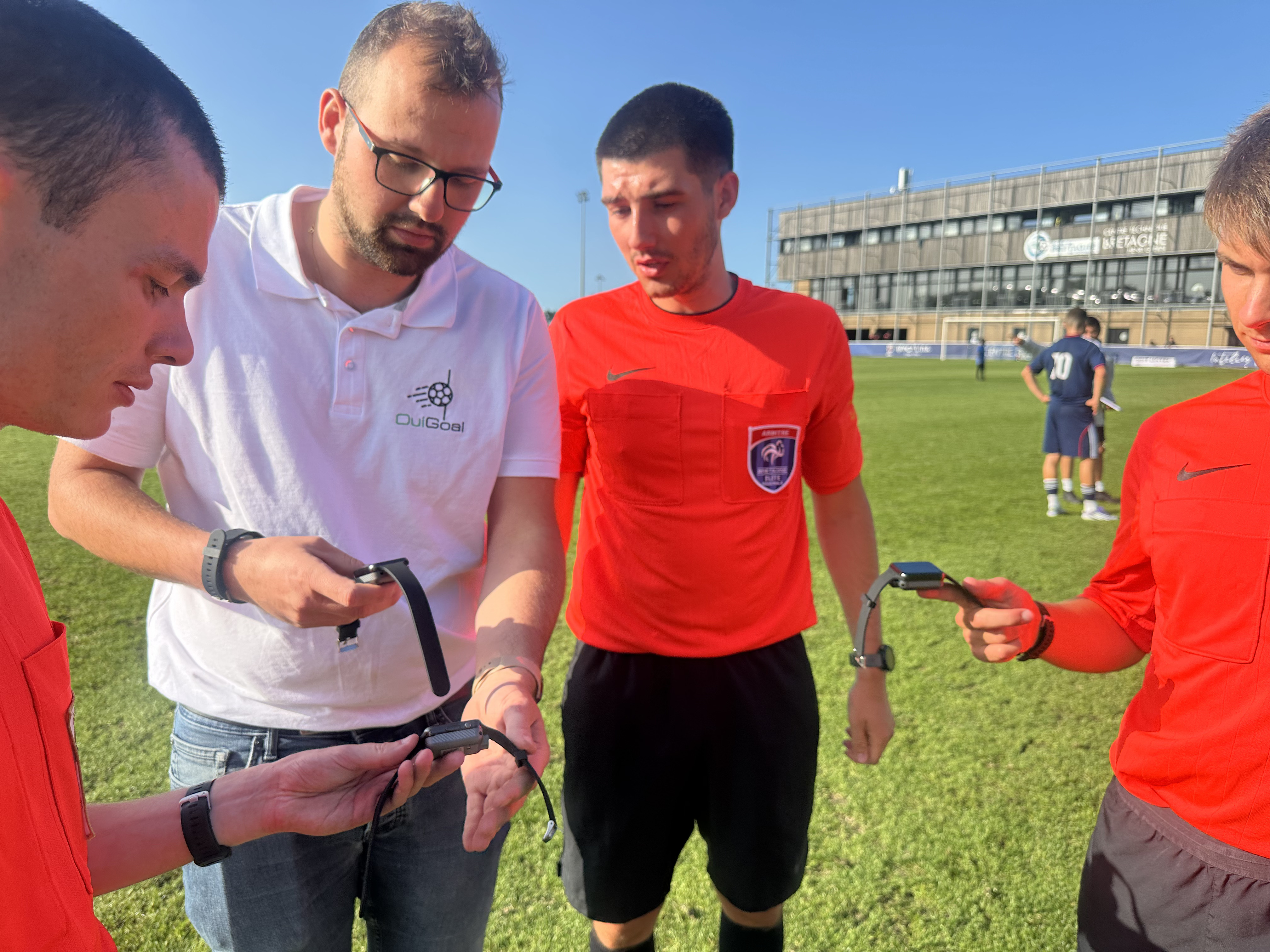 Referee watches demonstration on the pitch